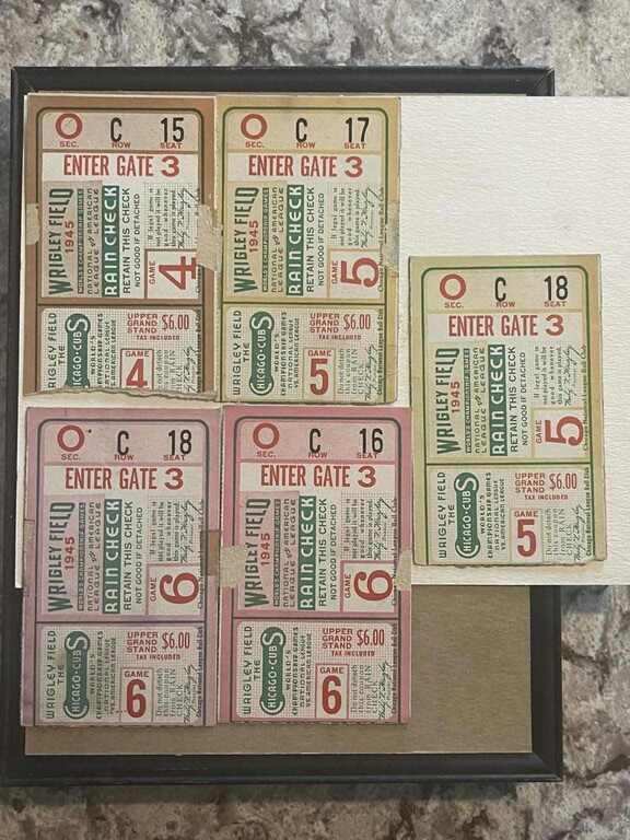 Five 1945 World Series Wrigley Field rain-check stubs mounted in a black frame