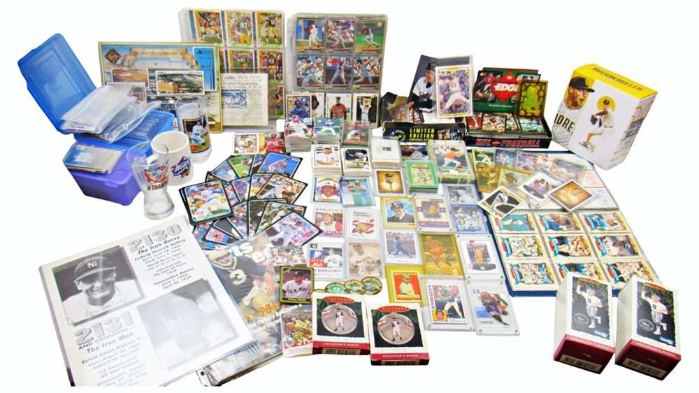 A big card collection: binder pages, stacks and boxes of baseball and football cards