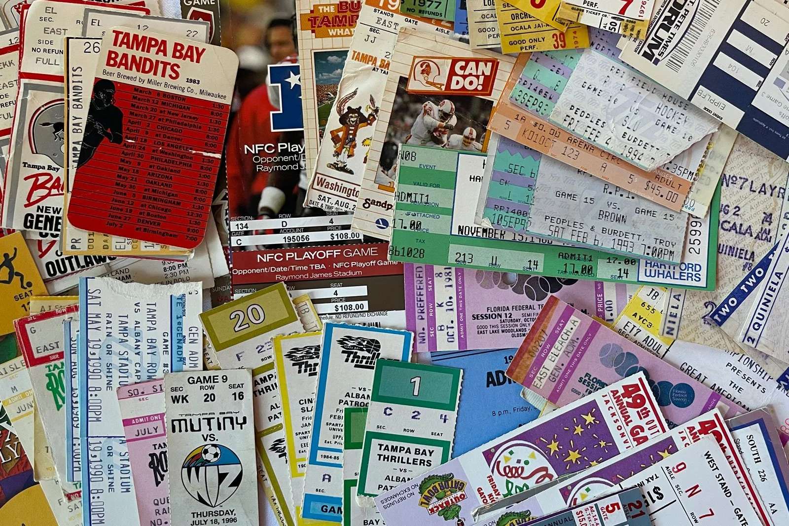 A big pile of colorful old ticket stubs from football, hockey and baseball games in the 1970s–90s